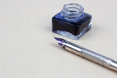 Vintage retro pen and inkwell on paper backgroundの写真素材
