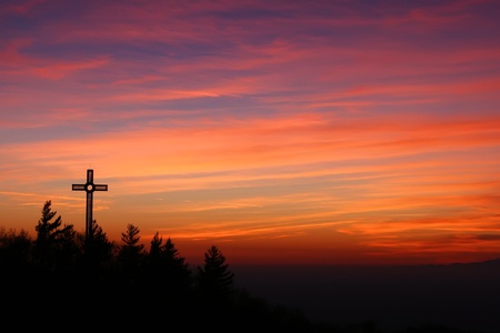 landscape with the cross at sunset seen from the sanctuary of castelmonte, udine, italyの写真素材