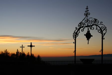 landscape, with the crosses and well, at sunset seen from the sanctuary of castelmonte, udine, italyの写真素材