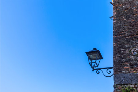 Old lamp for public lighting in the medieval village of Strassoldo. Friuli Italy.
