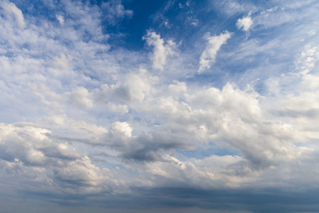 Blue sky, on the plain, with white and gray clouds that announce rain in summer.