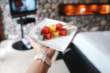 Fresh fruits sticks on a white plate, welcome fruit platterの写真素材