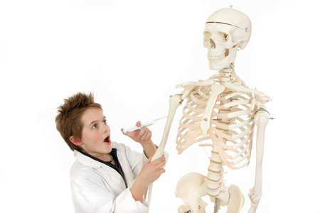 A boy disguising as a doctor injecting a skeleton