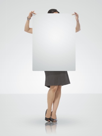 Teenager holding a Blank signboardの写真素材