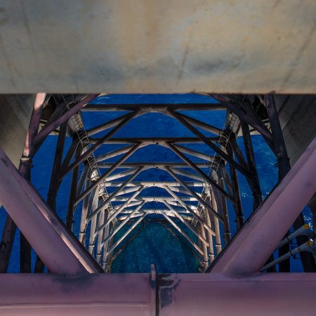 Jack up oil rig leg with blue sky when alomost fully up by motor in rig move operation