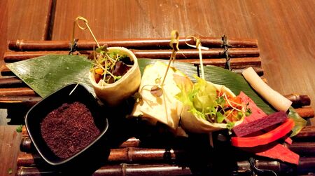 Chicken wrap/roll with salad on wooden backgroundの写真素材