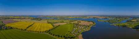 Panorama aerial view of the Schlei, an inlet of the Baltic Sea with rapeseed fields, near the village Missunde.の写真素材