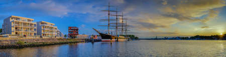 Panorama view of river Trave with the tall sailing ship Passat and the town skyline.の写真素材