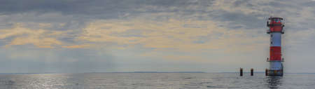 Panorama view of lighthouse Kalkgrund standing in the water in the Baltic Sea, Flensburg Fjord, Schleswig-Holstein, Germany. Leading and cross light in the Baltic Sea.の写真素材