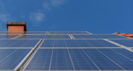 Solar panels on the red roof of a house. Solar panel, photovoltaic, alternative electricity source - concept of sustainable resources. Environmentally friendly electrical power supply.の写真素材