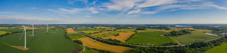 Panorama aerial view of countryside infrastructure with highway, windmills, agriculture fields and farm.Agriculture fields and different variety of harvest, from the air perspective, Germany, Europe.の写真素材