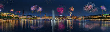 Panorama view of city center from Alster Lake, view to Hamburg Rathaus and fountain in the center of the lake with fireworks. Festive atmosphere with fireworks in Hamburg. Port birthday in Hamburg.の写真素材