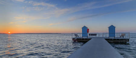 Panorama view of sea with pier on sea against cloudy sky during sunset. Pier in the municipality of Stein (Baltic Sea), Probstei, Schleswig-Holstein, Germany.の写真素材