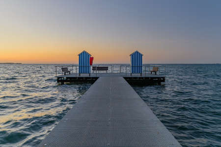 View of sea with pier on sea during sunset. Pier in the municipality of Stein (Baltic Sea), Probstei, Schleswig-Holstein, Germany. Bathing area on Baltic sea.の写真素材