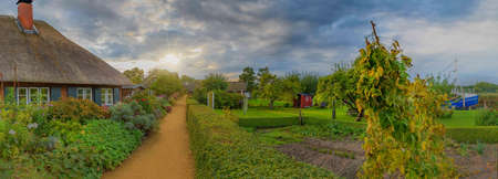 Panorama view of picturesque village with autumn natural landscape. Architecture thatched houses in fishing village, Schleswig-Holstein, Germanyの写真素材