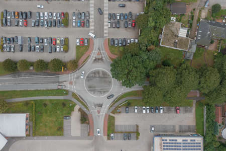 Aerial view fragment of parking in front of supermarkt and roundabout with cars.の写真素材