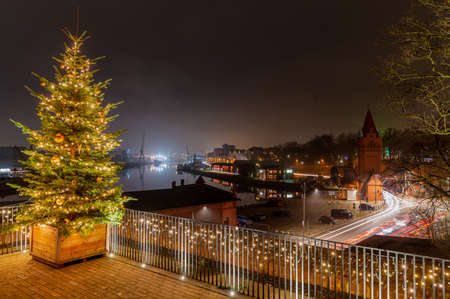 View of Christmas Tree with festive lighting and Christmas romantic atmosphere on the river Trave in the Hanseatic city of LÃ¼beck at night. Nighttime view of LÃ¼beck at Christmas time.の写真素材