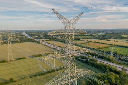 Power line, power supply with countryside landscape. Electricity grid expansion for the energy transition. Electricity pylons.の写真素材