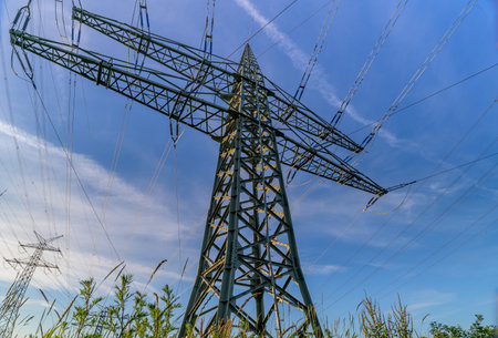 Power line, power supply with countryside landscape. Electricity grid expansion for the energy transition. Electricity pylons.の写真素材
