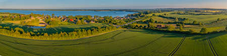 Panoramic aerial view of idyllic countryside with blue lake, HÃ¼ttener Berge, Schleswig-Holstein, Germany. The idyllic landscape in the lake district Wittensee and the nature park Hの写真素材