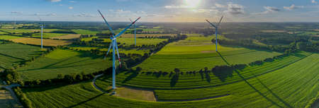 Panoramic aerial view of countryside with windmills and agriculture fields. Landscape with corn, grain, maize fields and different varieties of harvest, from the air perspective, Germの写真素材