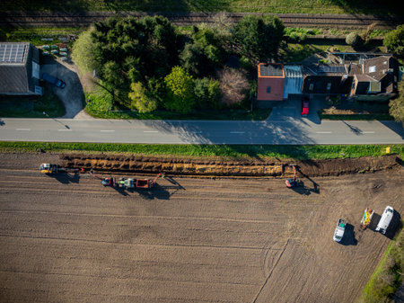 Aerial view of a tractor working on a new road construction siteの写真素材