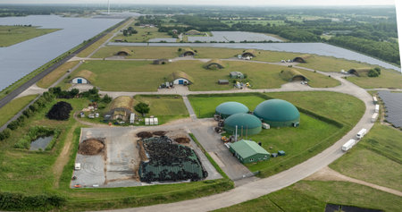 Aerial view of renewable energy site with biogas domes, combined heat and power station, solar fields, silage storage, repurposed munitions depot as sustainable infrastructure in Rの写真素材