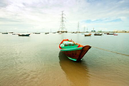 fishing boat with power plant backgroundの写真素材