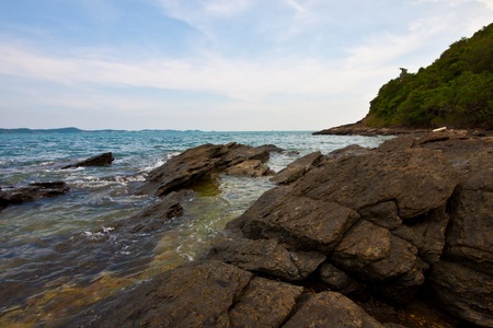 view through rocks on coastline of beach of seaの写真素材