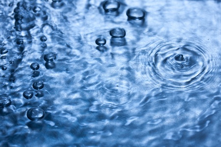 Water drop on blue backgroundの写真素材