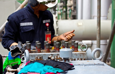worker are repairing stroke pump in petrochemical plantの写真素材