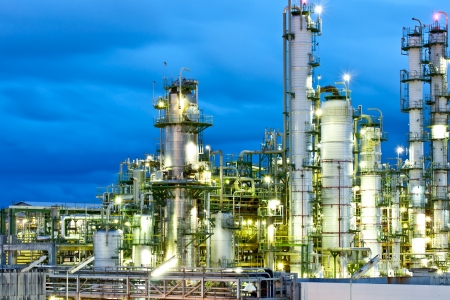 tower in petrochemical plant at night time tower in petrochemical plant at night time