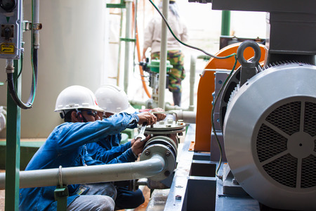 two workers cleaning filter of strainerの写真素材