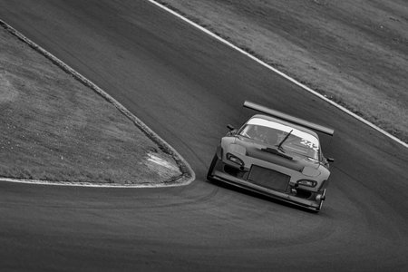 A shot of a racing car as it circuits a track.