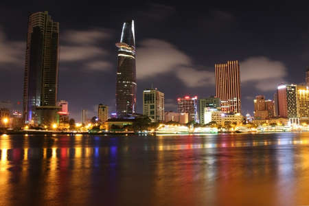 Long exposure and reflection of the Ho Chi Minh City skyline at night in Vietnamのeditorial素材