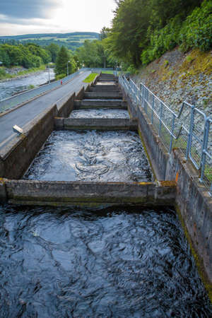 Pools or chambers with flowing water in the salmon ladder at Pitlochry dam on the River Tummel, Scotlandの写真素材
