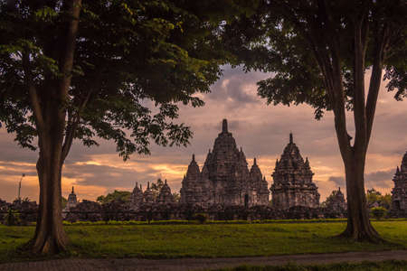 Sewu temple through the trees at sunset, Prambaban complex, Yogyakarta, Indonesiaの写真素材
