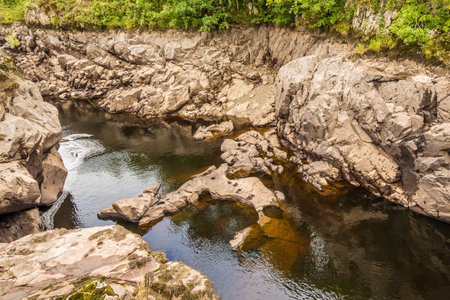 Strange rock formation due to the physical abrasion and scouring of a river, by rocks and water in a...