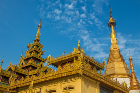 A golden buddhist temple in the evening sun in Yangon, Myanmar