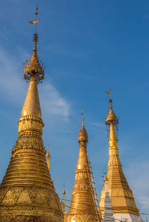 The stupas of the Shwedagon Pagoda in the evening sunlight, in Yangon, Myanmarのeditorial素材