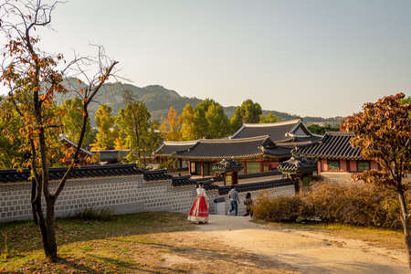 Seoul, South Korea - October 19th 2017: Women in hanboks walking at Gyeongbokgung Palace, Seoul, South Koreaのeditorial素材