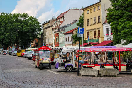 Krakow, Poland - July 29th 2018: Electric tourism tour buggies parked at Szeroka street and square, Kazimierz, Jewish Quarter, Krakow, Polandのeditorial素材