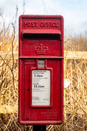 Glenlee, Scotland - December â24, â2020: Red British Royal Mail, Lamp Post office box in a rural settingのeditorial素材