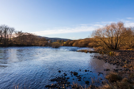 Winter sunset on a treelined Water of Ken at St. John's Town of Dalry, Scotland