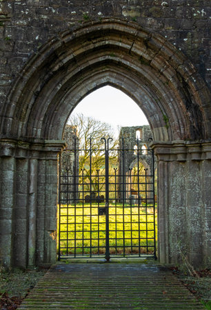 Gated archway entrance at Dundrennan Abbey, a medieval abbey in Dumfries and Galloway, Scotland