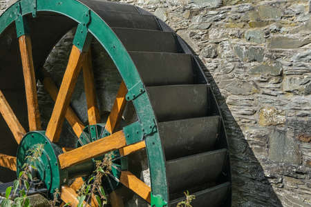 Green wooden and metal water wheel at the old cotton mill on the Water of Fleet at Gatehouse, Dumfries and Galloway, Scotlandの写真素材