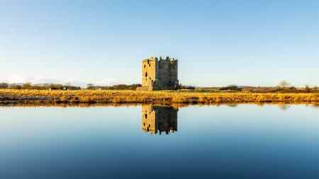 Threave Castle reflecting on a calm River Dee in the winter sun, Dumfries and Galloway, Scotlandのeditorial素材