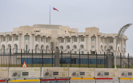 The Al-Adaam National Flag of Qatar flying above the Amiri Diwan Parliament Building in Doha, Qatar