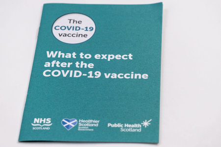 Galloway, Scotland - December 29th 2021: What to expect after the Covid-19 vaccine booklet, NHS...