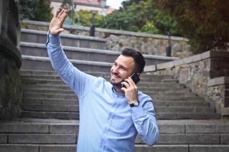 Portrait of a bearded man near the big steps of an old European castle. Businessman thinking over a future project. Fashionable guy with stylish clothes.の写真素材
